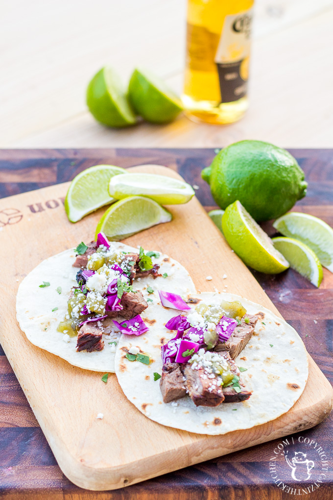 These steak street tacos are super tasty and incredibly easy to make! An inexpensive cut of steak works great, grilled alongside corn tortillas, with a fresh cabbage and salsa topping!