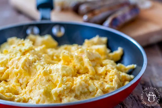 This incredibly simple four-ingredient recipe results in the best cheesy scrambled eggs we know how to make! Breakfast, brunch, or breakfast for dinner!