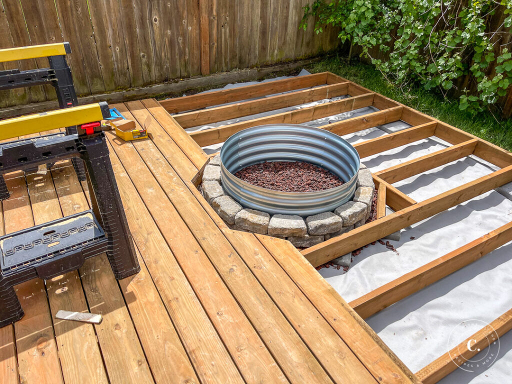 laying decking around fire pit on floating deck frame 
