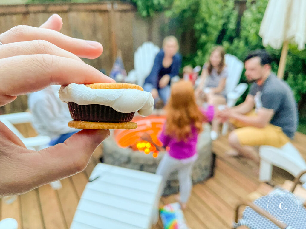 roasting s'mores around DIY fire pit on floating deck 