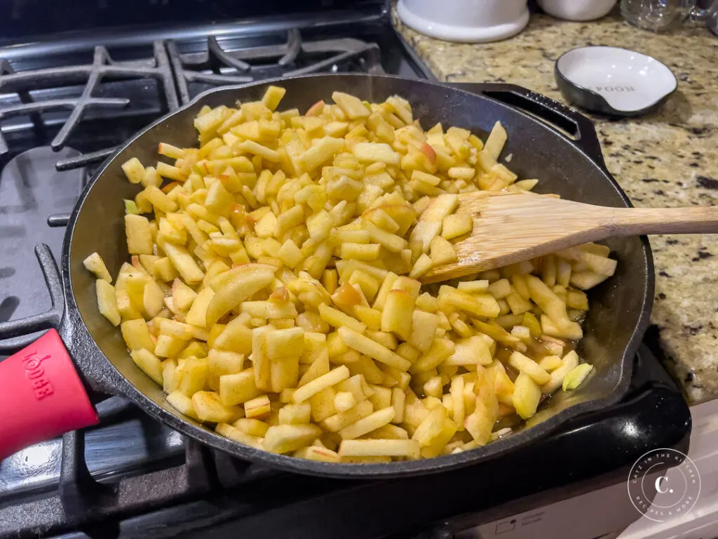 cooking apple mixture in cast iron for Apple Pie Ricotta Waffles