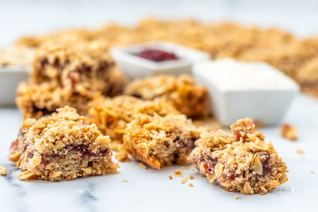 Coconut Raspberry Oat Bars cut into squares